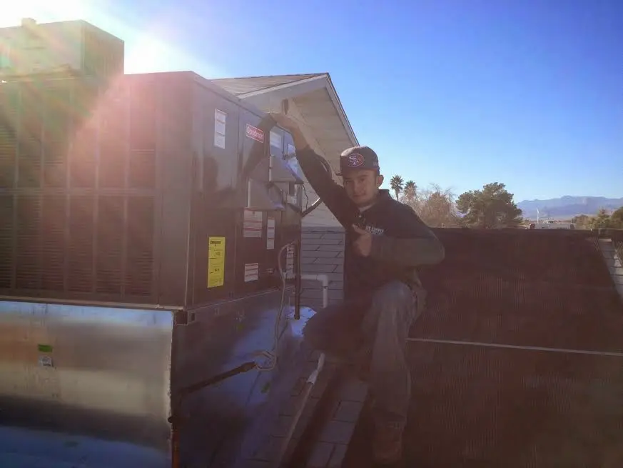 HVAC technician performing Air Duct Repair on a rooftop unit in Harriman